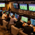 ONE88 sports betting enthusiasts analyzing odds in a vibrant setting
